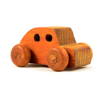 An isolated over a white background frontal view of a wood car toy.