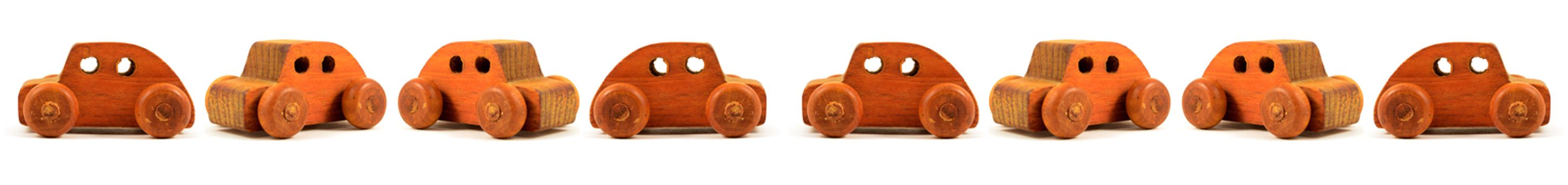 A seamless border detailing an isolated over white set of wooden toy cars.