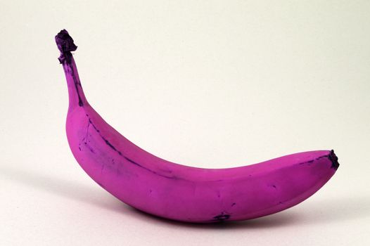 A closeup of a purple banana that has been purposely adjusted to show an abstract brain tease of reality.