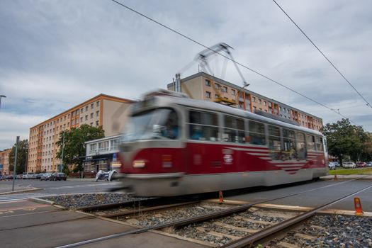 Tram driving between big residential buildings Panelaks in Prague Czech Republic