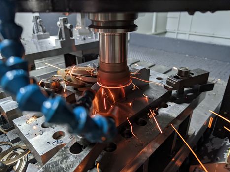 cnc milling of hardened steel with sparks - closeup with selective focus and blur.