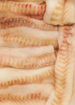 Fish fillet lying on ice in a shop window, store counter or supermarket.