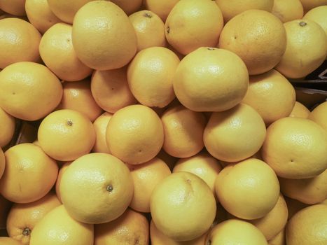 Fresh ripe oranges in a shop window, store counter or supermarket.