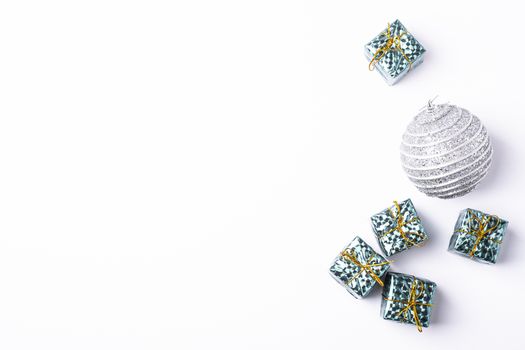 Christmas New Year composition. Gifts, silver ball decorations on white background. Winter holidays concept. Flat lay, top view, copy space