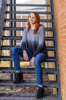 A gorgeous redhead model enjoys a spring day outdoors