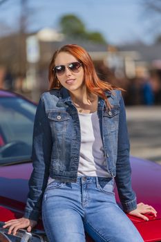 A gorgeous redhead model enjoys a spring day outdoors