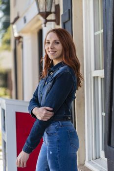 A gorgeous redhead model enjoys a spring day outdoors