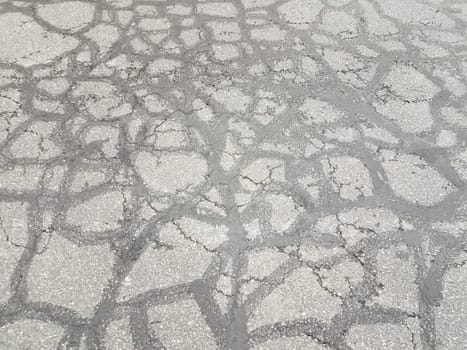 cracks and lines repaired damage in black asphalt or pavement