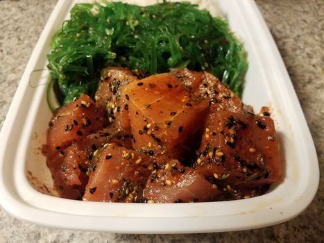 raw Hawaiian tuna with sesame seeds and green seaweed