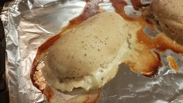 seasoned chicken breast on metal foil baking tray