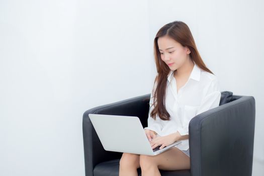 Beautiful of portrait young asian woman using laptop for leisure on sofa, girl working online internet with notebook freelance, communication business concept.