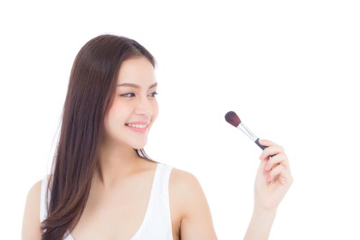 Beauty asian woman applying make up with brush of cheek isolated on white background, beautiful of girl holding blusher, skincare and cosmetic concept.