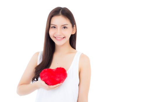 Portrait of beautiful asian young woman holding red heart shape pillow and smile isolated on white background, valentines day, holiday concept.