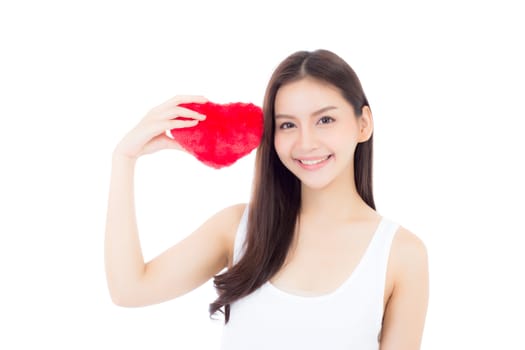 Portrait of beautiful asian young woman holding red heart shape pillow and smile isolated on white background, valentines day, holiday concept.