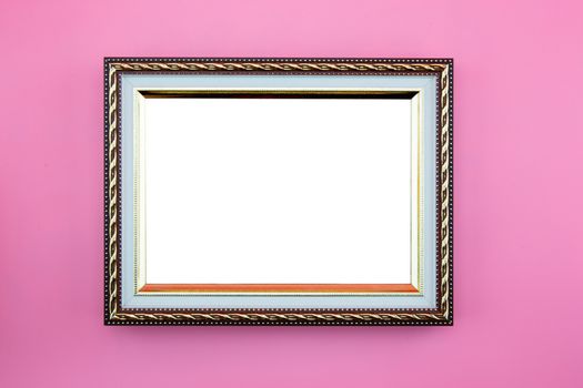 Gold frame photo border or picture with copy space isolated on pink background, portrait image gallery.