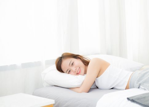 Portrait of beautiful asian young woman sleep lying in bed with head on pillow comfortable and happy with leisure, girl with relax  for health and lifestyle concept.