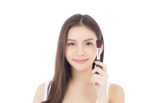 Beauty asian woman applying make up with brush of cheek isolated on white background, beautiful of girl holding blusher, skincare and cosmetic concept.
