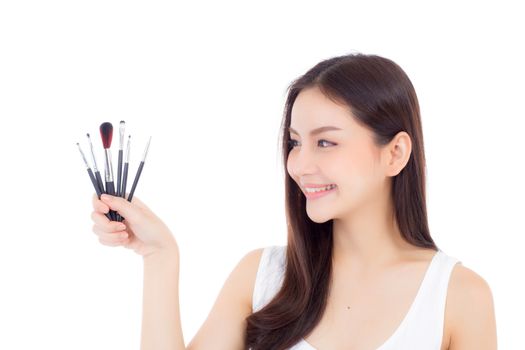 Beauty asian woman applying make up with brush on hand isolated on white background, beautiful of girl holding blusher, skincare and cosmetic concept.