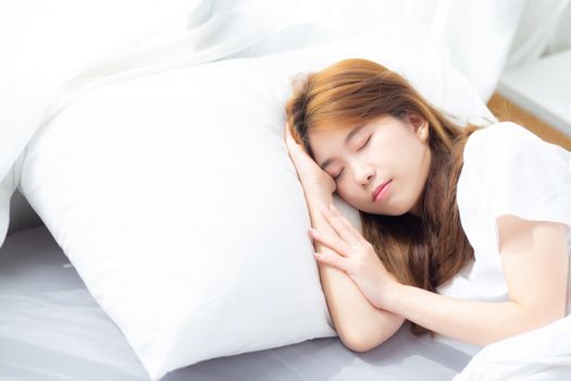 Portrait of beautiful asian young woman sleep lying in bed with head on pillow comfortable and happy with leisure, girl with relax  for health and lifestyle concept.