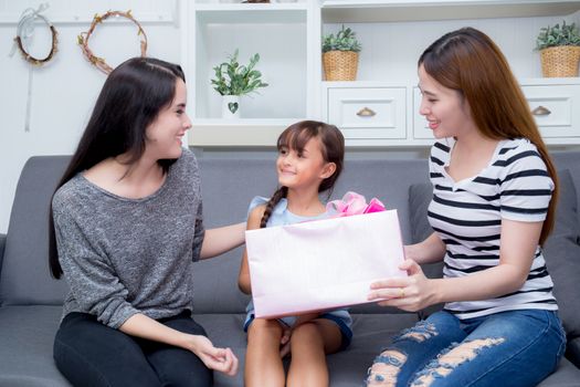happy of mother and daughter woman asian and aunt with gift with pink ribbon and daughter kissing mother, Happy family concept. Happy mother's day.