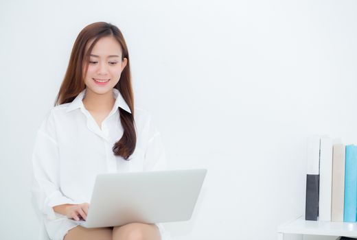 Beautiful young asian woman using laptop for leisure on sofa, girl working online with notebook freelance, communication business concept.