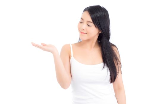 Asian beautiful young woman showing with healthy clean skin presenting something empty copy space on the hand isolated on white background, beauty concept.