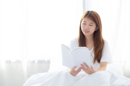 Beautiful of portrait young asian woman relax sitting reading book on bedroom at home, girl study literature, education and llifestyle concept.