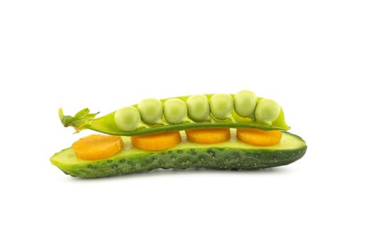 Healthy fresh vegetable sandwich over white with carrots, peas in a pod and cucumber balance on top of each other
