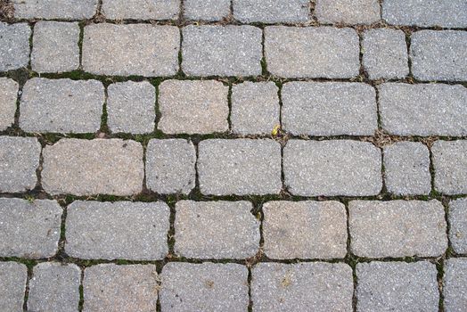 Beautiful full frame background image of old weathered paving stones / cobblestones. Subtle colors and textures.