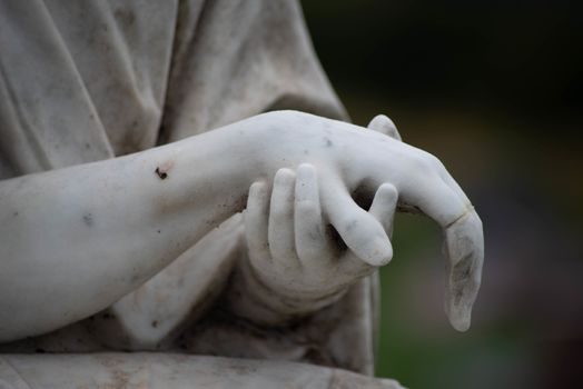 Victorian cemetery pieta hands of Jesus and Mary in white stone. Full frame, shot in natural light with copy space.