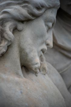 Full frame image of sculpted Jesus face on  Victorian cemetery pieta. Selective focus draws the eye toward the facial features.