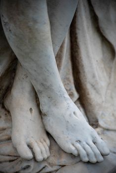 Beautiful Victorian cemetery statue, Jesus's feet show stigmata. Full frame in natural light. Beautiful detail.