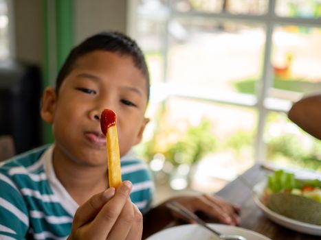 French fries with tomato sauce In the boy's hand