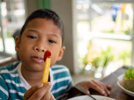 French fries with tomato sauce In the boy's hand