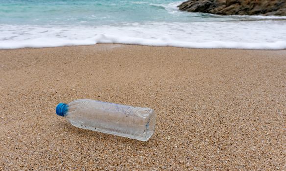 Plastic bottle waste is an environmental pollution on the beach.