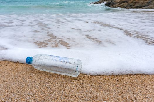 Plastic bottle waste is an environmental pollution on the beach.