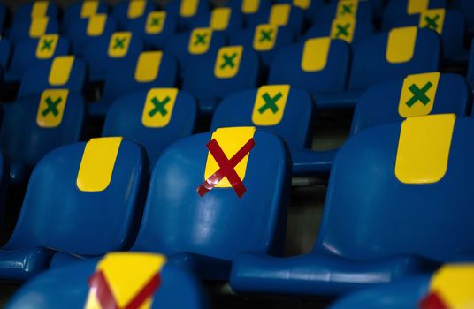 Seat with Red symbol sticker placed on a chair in plublic for one seat from other people keep distance protect from COVID-19 or coronavirus for New normal lifestyle