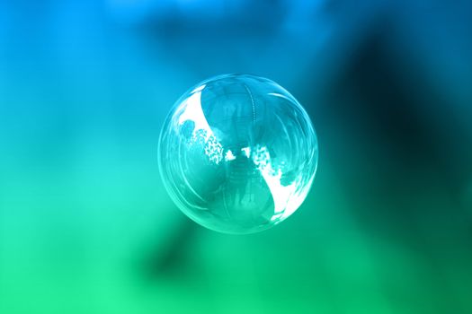 1 soap bubble on a green and blue background.