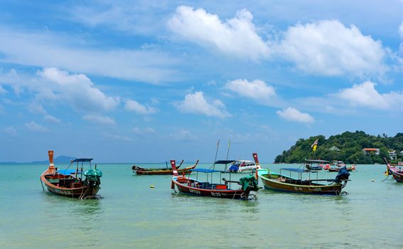 Phuket, Thailand - 06 August 2020: Fishing boats moored at Chalong Bay Pier.