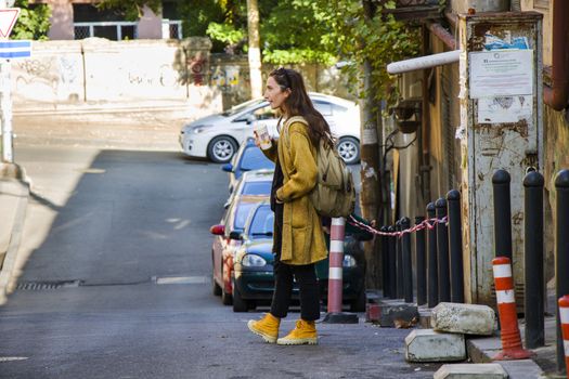 Woman in the casual cloth and yellow boots in the street, Tbilisi, Georgia