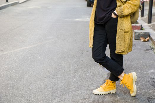 Woman in the casual cloth and yellow boots in the street, Tbilisi, Georgia