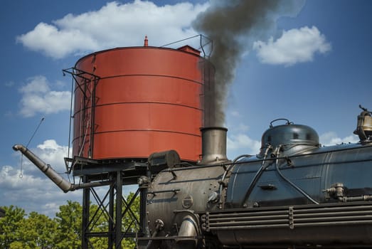 Steam Engine to get Water by Water Tower on a Sunny Day