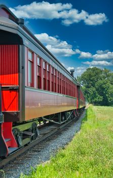 Steam Passenger Train Traveling Thru Countryside from Train View on a Sunny Day