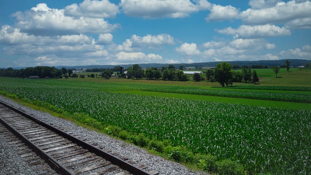 Steam Passenger Train Traveling Thru Countryside from Train Passenger View