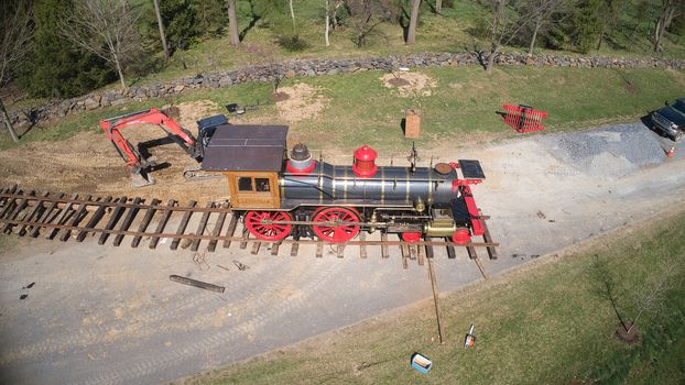 Aerial View of a Replica of an Old 1860's Steam Engine Being Assembled onto the Tracks Ready on a Sunny Spring Day
