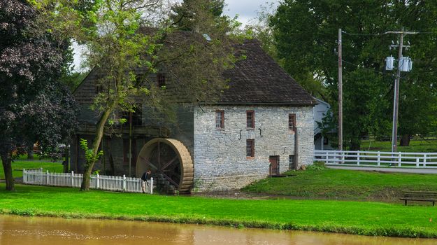 Old Water Wheel Grinding Mill Stone Building on an Autumn Day