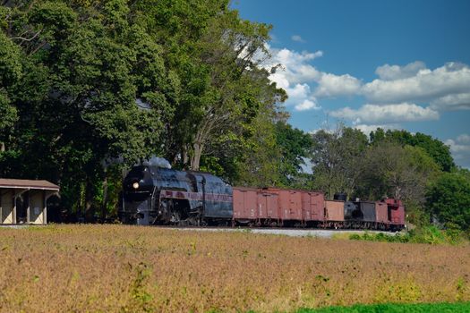 Antique Steam Freight Train Puffing Smoke and Steam While going Thru Amish Countryside
