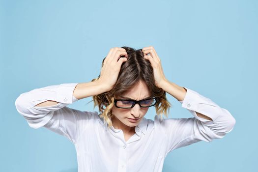 Business woman in a light shirt on a blue background gestures with her hands emotions model work. High quality photo