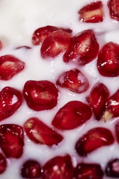 Pomegranate seeds, in yogurt. macro photography