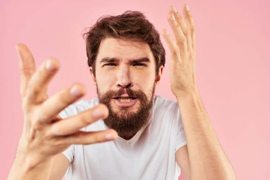 Bearded man white t-shirt cropped view lifestyle studio pink background. High quality photo